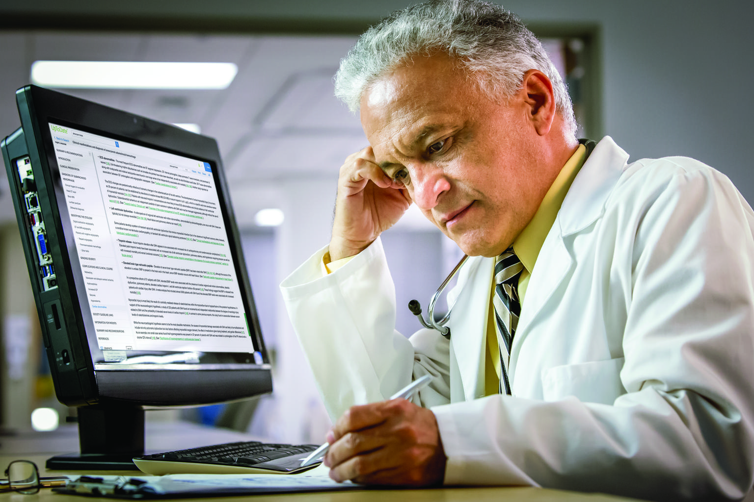 doctor reading notes at computer