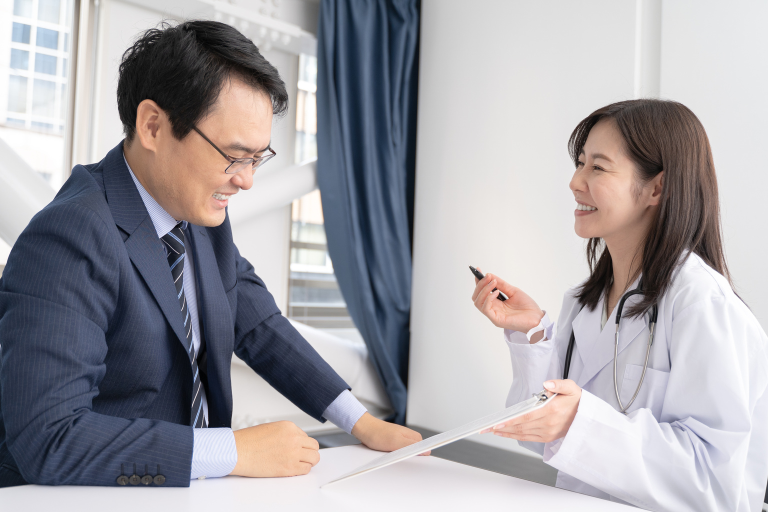 Female doctor and male patient explaining the medical condition