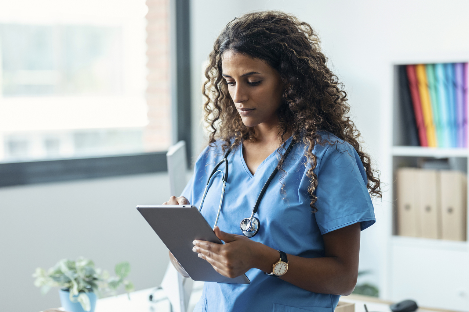 Medical professional uses tablet to review information about a patient 