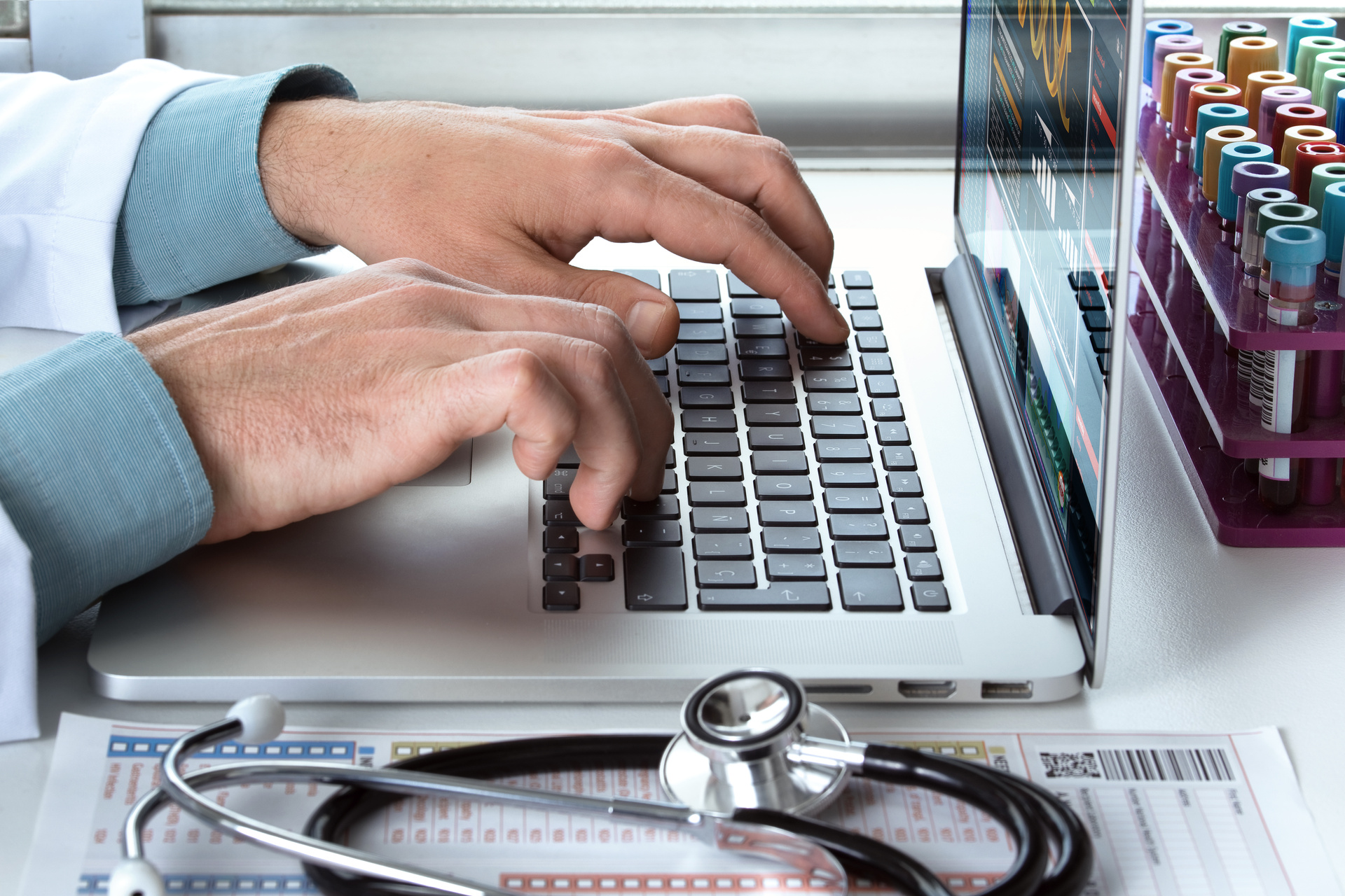 Medical Professional Typing On Laptop