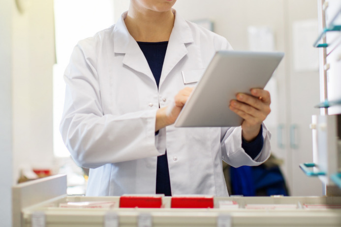 Clinician reviewing medication tray management using an iPad.