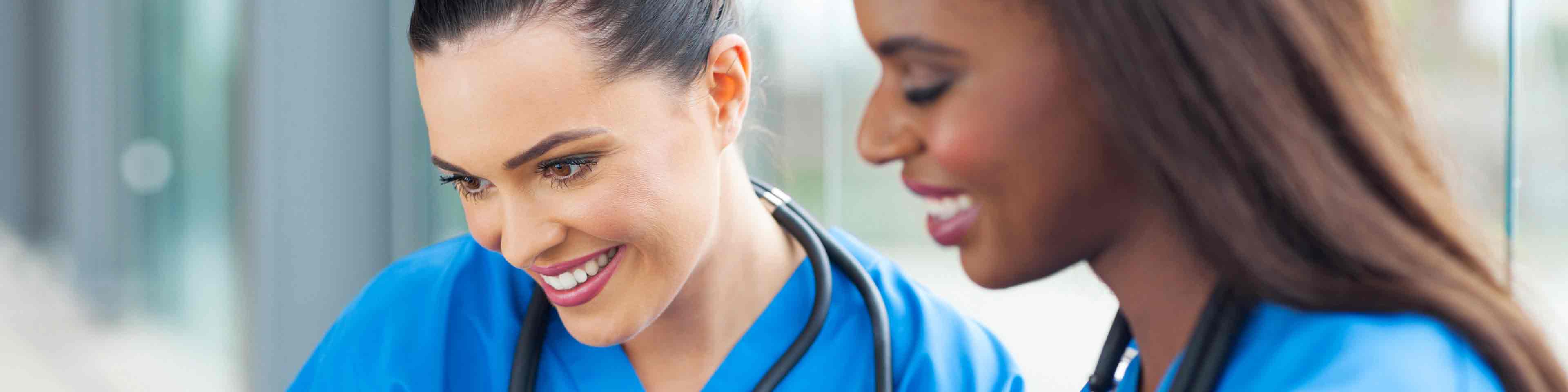 Two healthcare workers using laptop