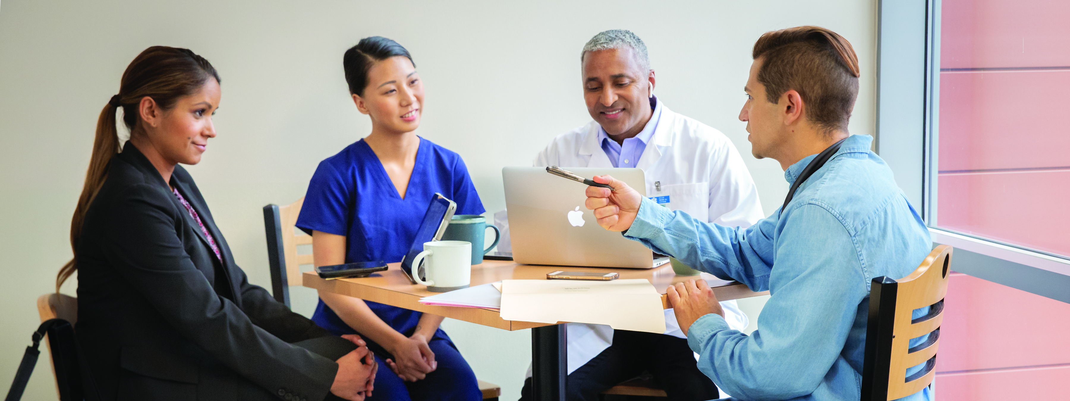 Group of Healthcare workers and hospital staff sitting at table in a meeting