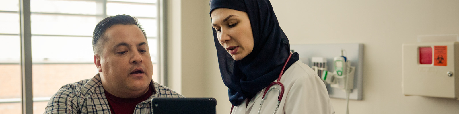 Patient instructing a doctor off a tablet