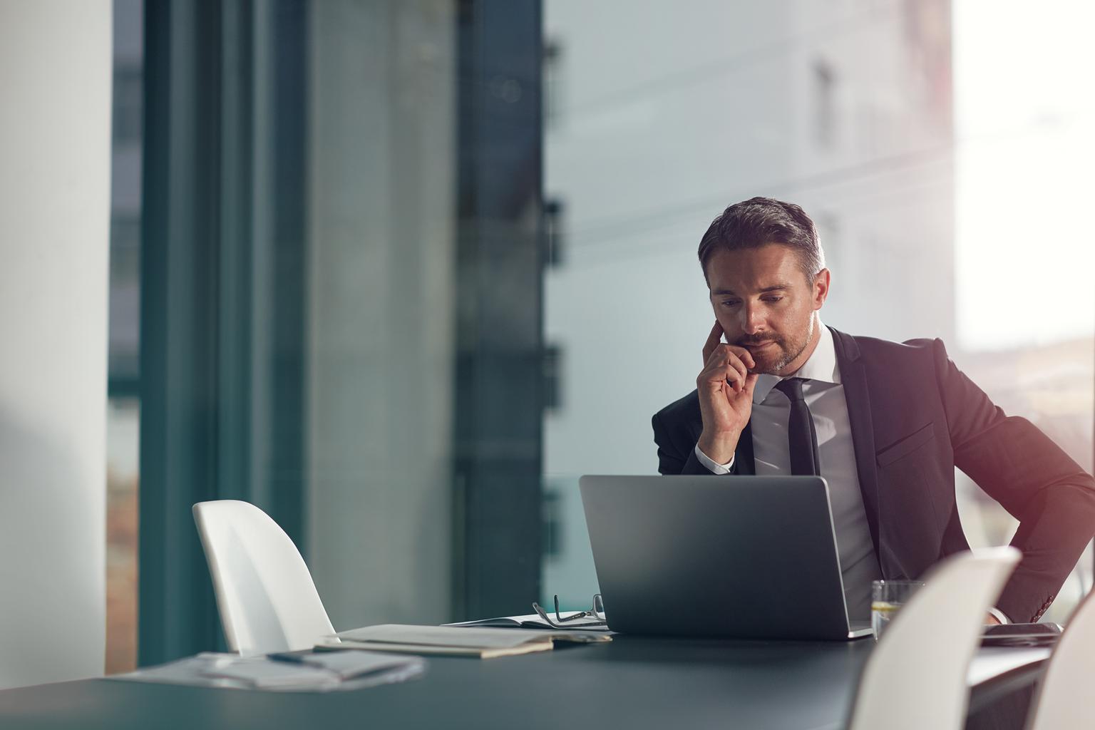 Laptop thinking and office with a businessman.