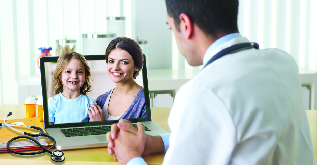 Image of a mother and child on a computer screen simulating a telemedicine appointment from the perspective of a doctor.