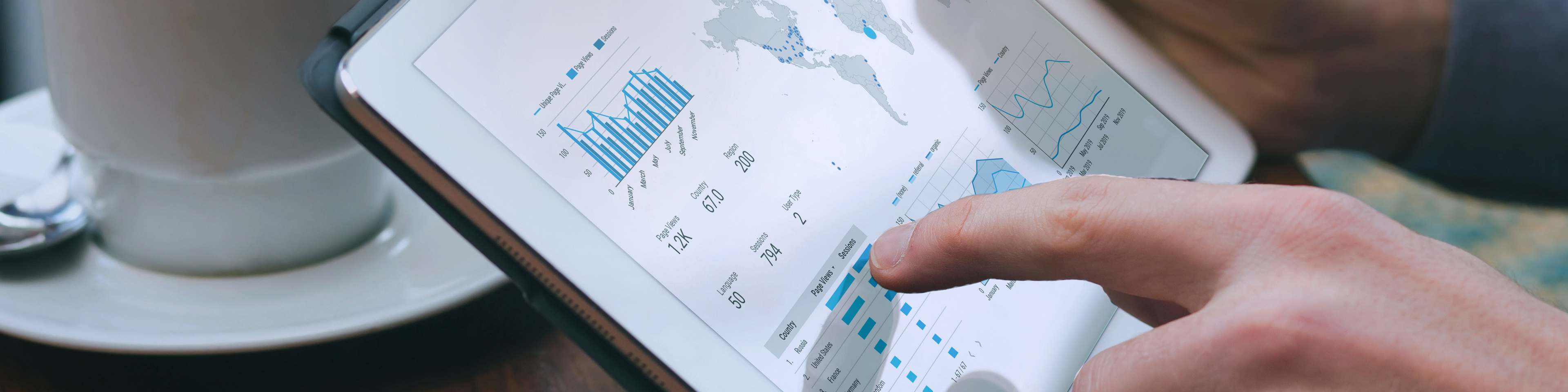 Businessman examining graphs and data on a tablet