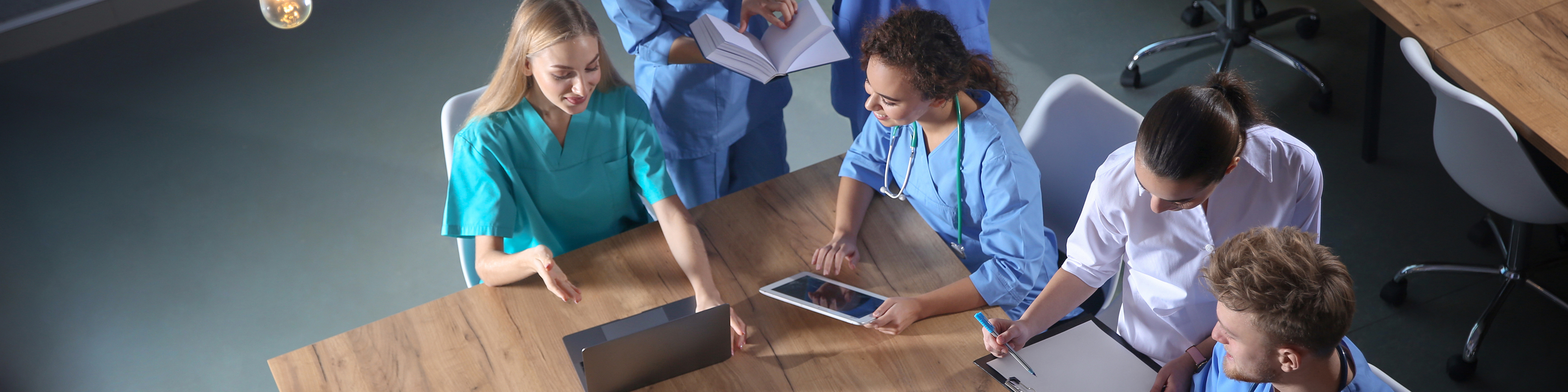 Group of medical students with gadgets in college, top view