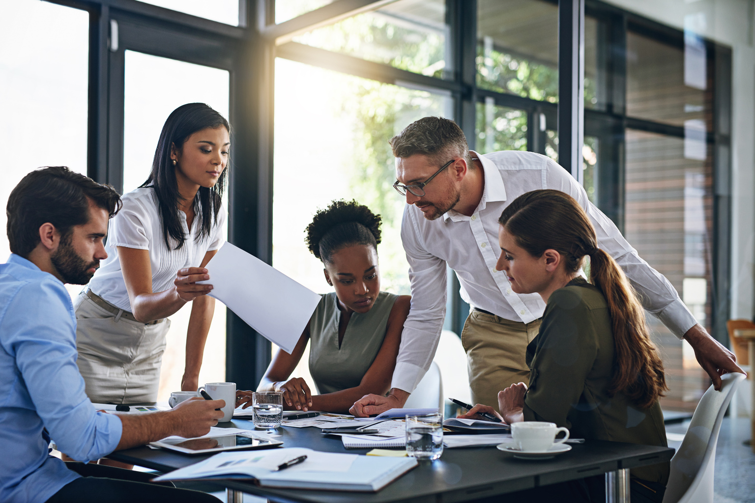 Employees discussing reports in the conference room