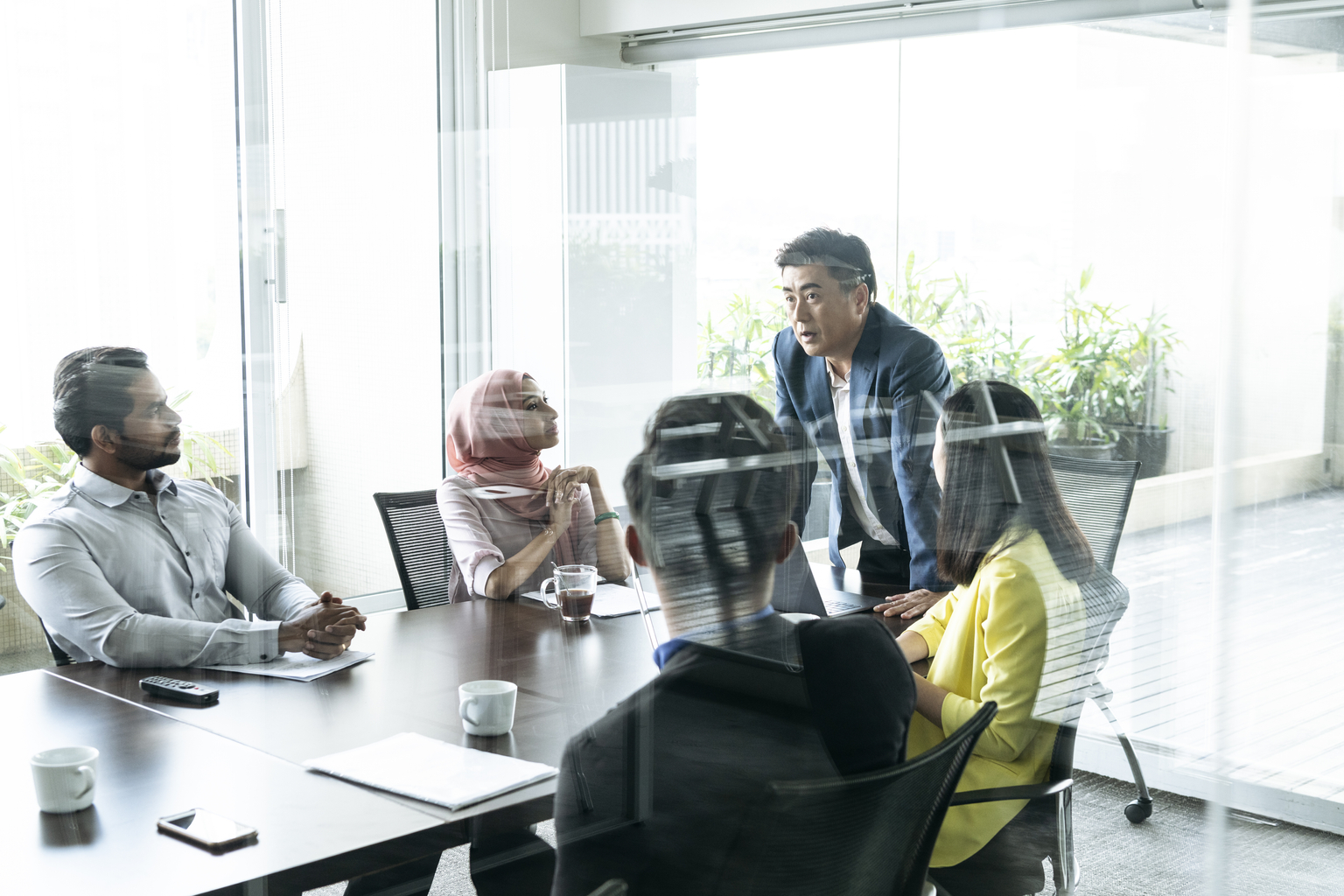 Multiethnic employees discussing a project in a conference room