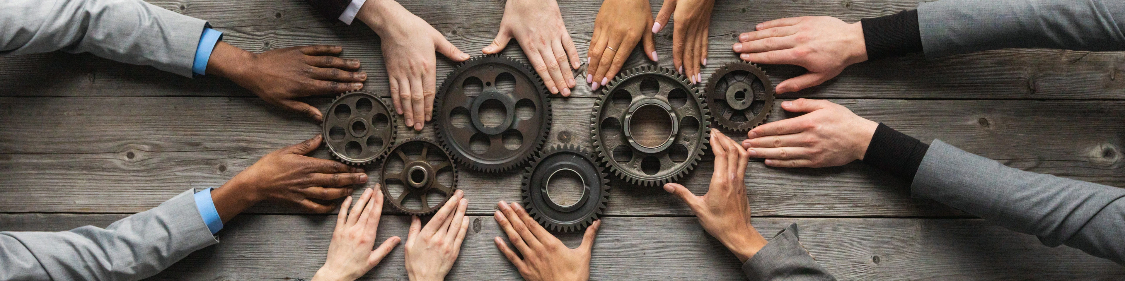 Combined Assurance Hands Holding Gears