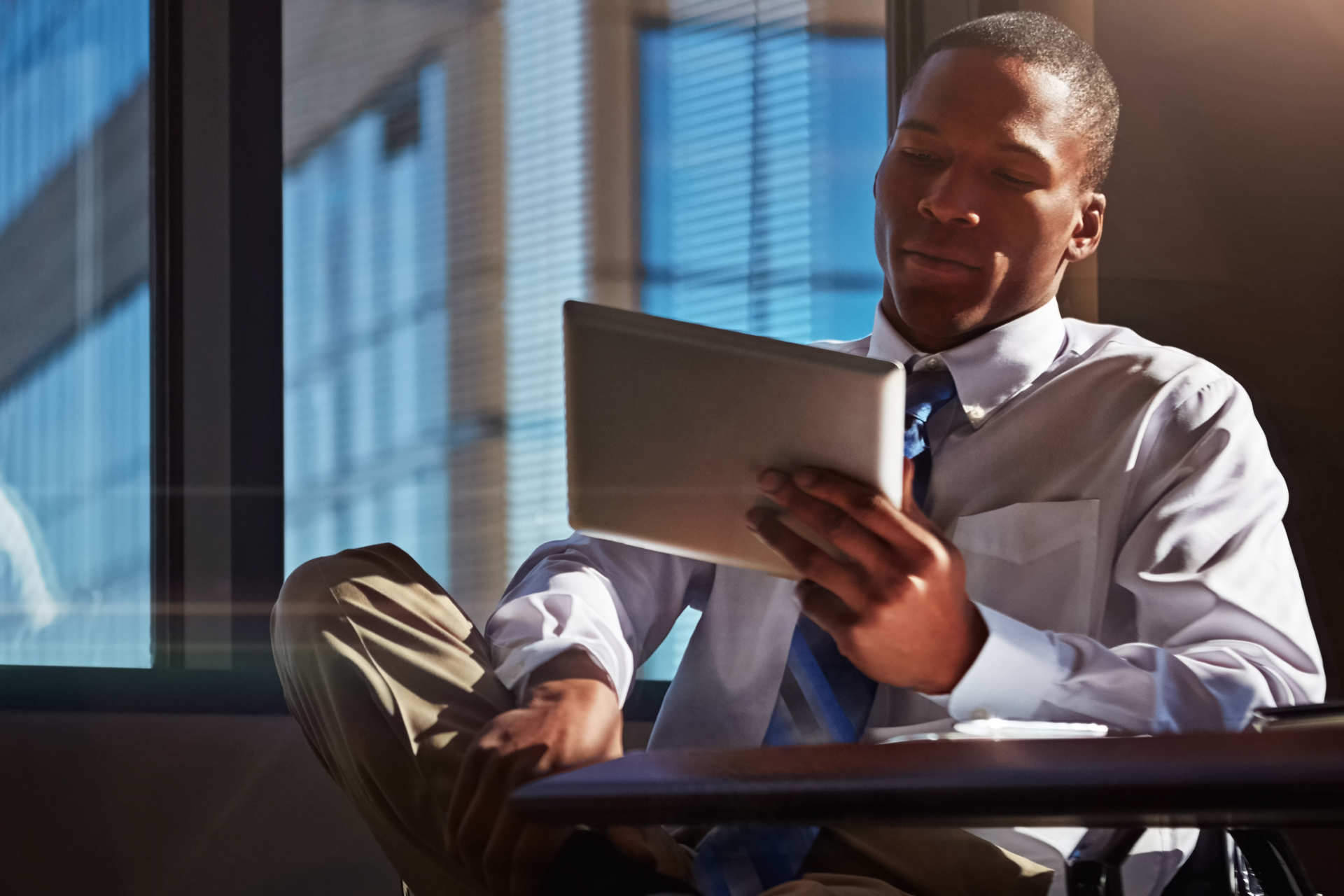 sitting man holds tablet