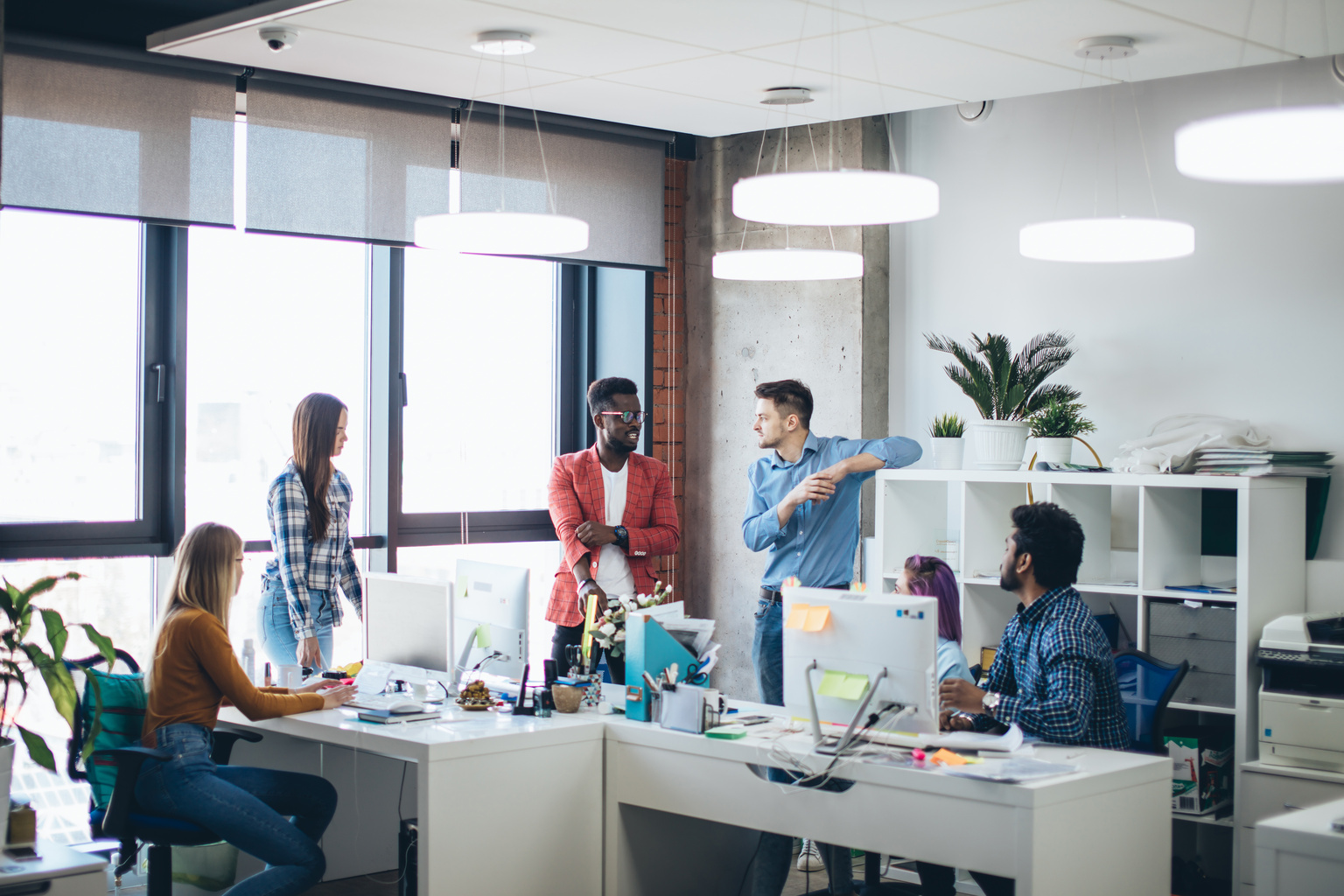 modern business office interior with colleagues talking