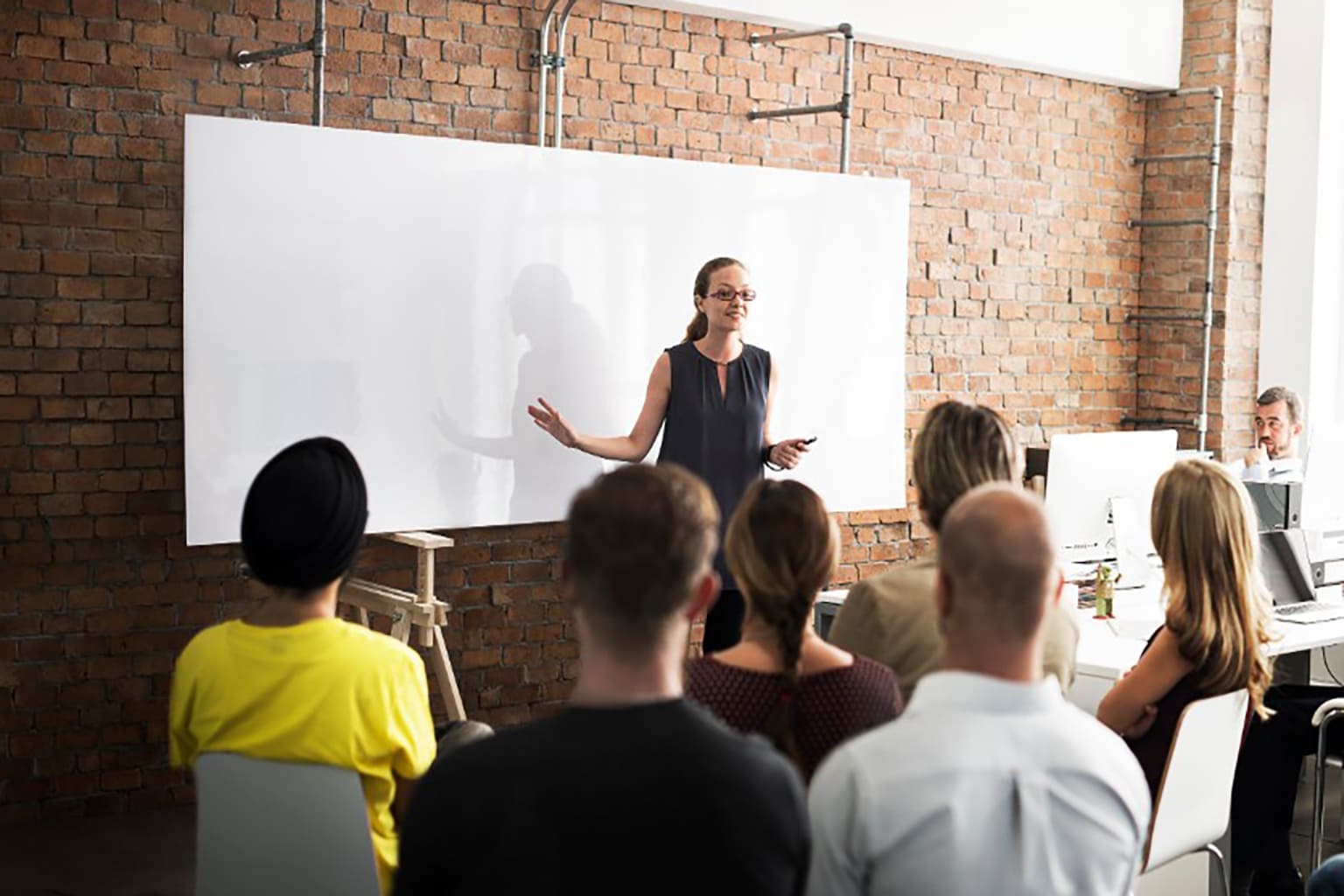 Trainer heeft groep leerlingen uitleg over boekhouden