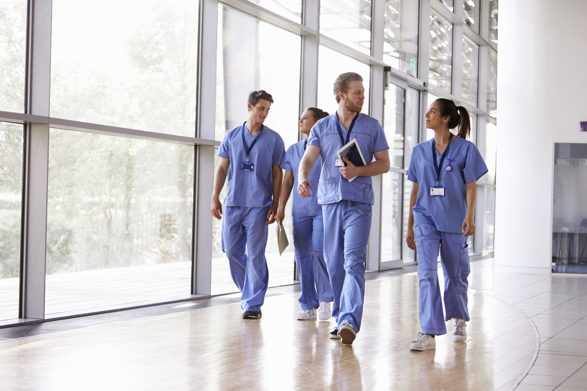 Doctors walking down a hallway while talking<