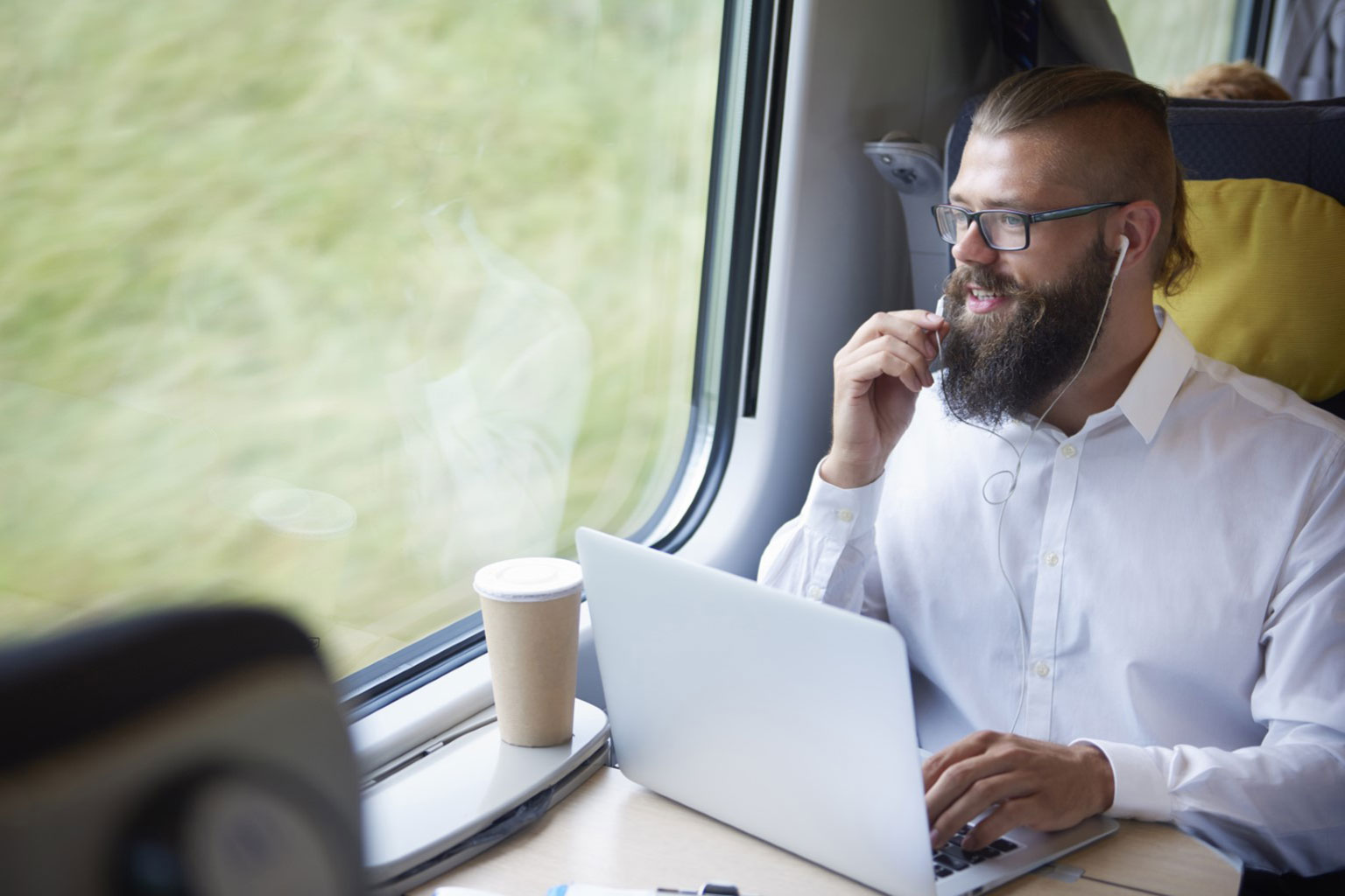 Person on train with laptop