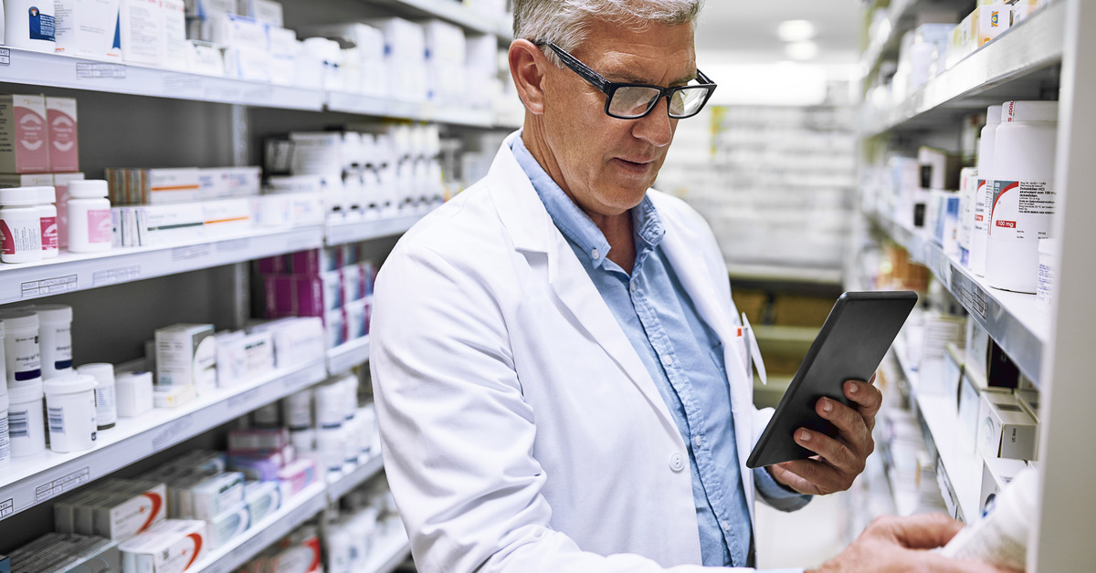 Shot of a focused mature male pharmacist making notes of the medication stock on the shelves in a pharmacy