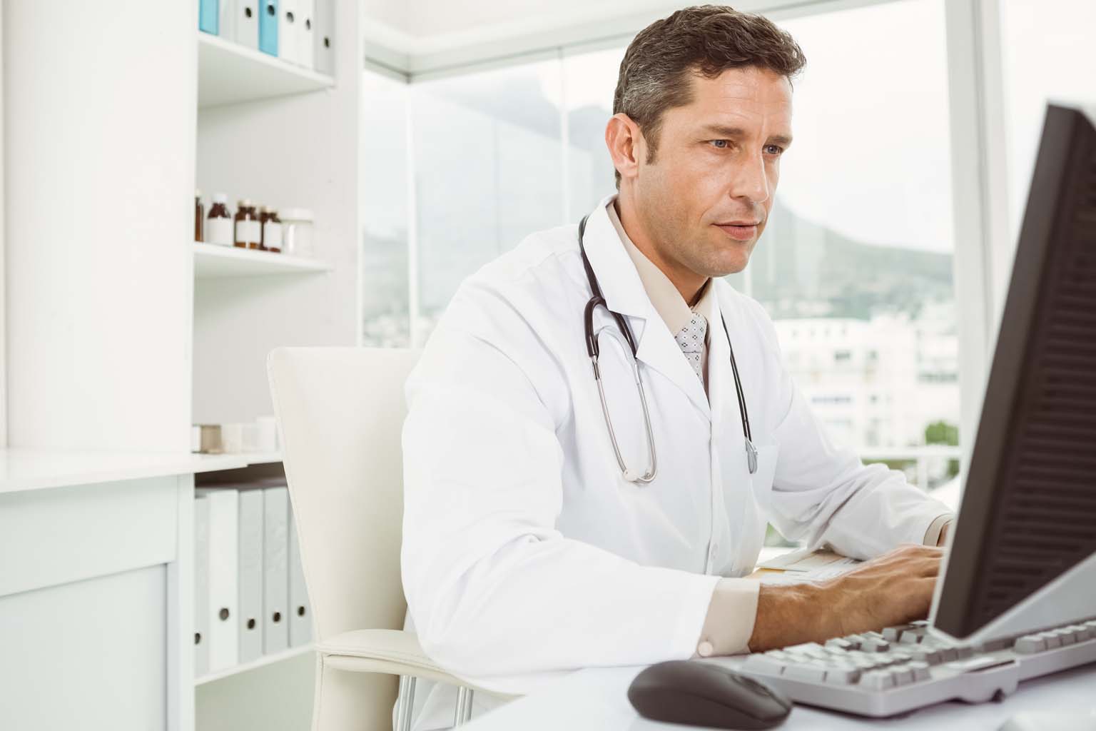 pharmacist using computer in pharmacy