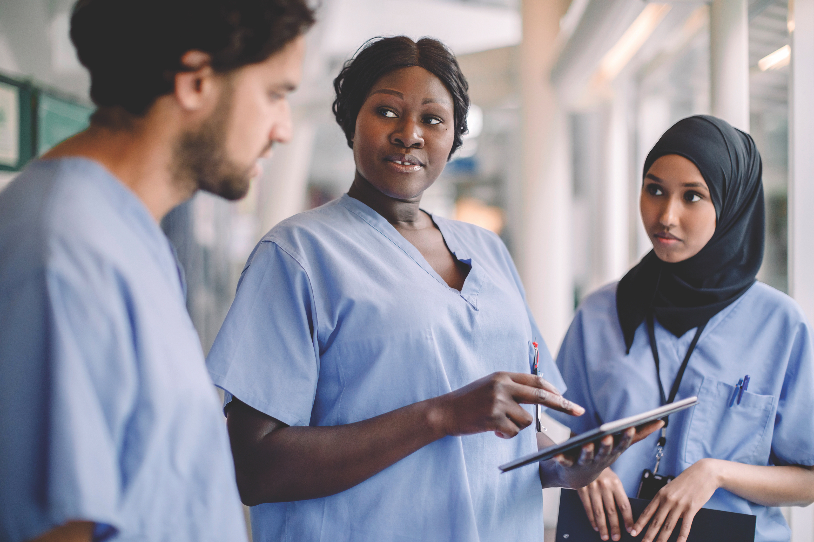 Nurses reviewing material on tablet