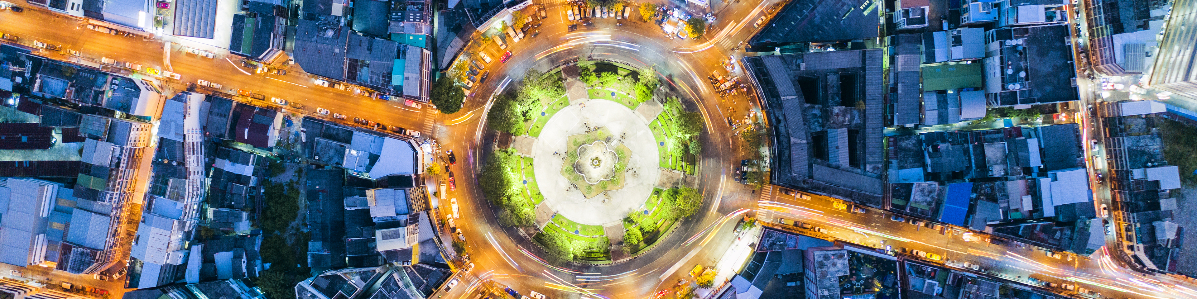 Aerial top view of roundabout of road with light trails,car lots on the road at night in Wongwainyai, Bangkok,Thailand, 