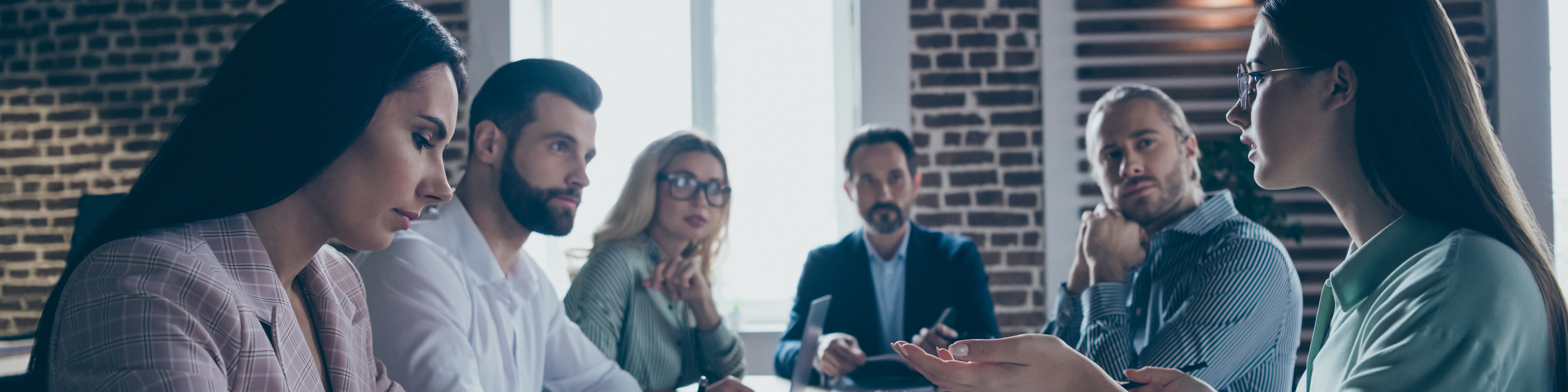 Business professionals sitting around table having a discussion