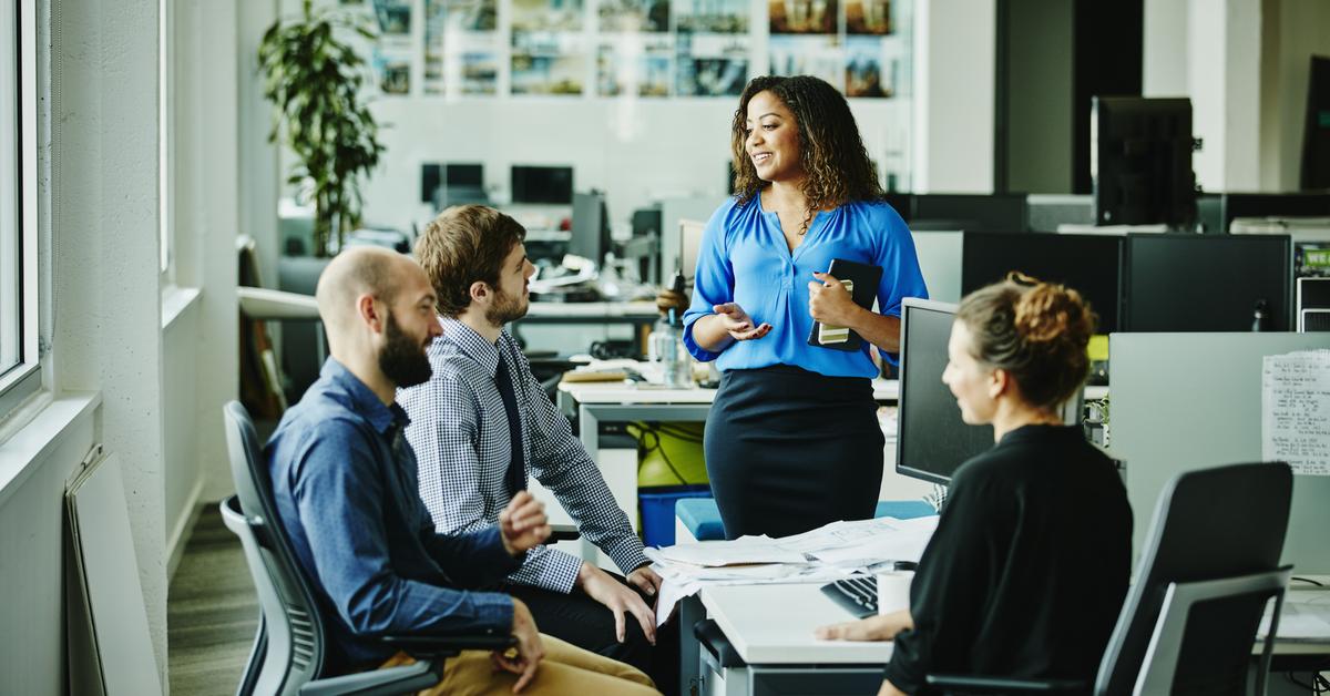 Businesswoman leading meeting with colleagues