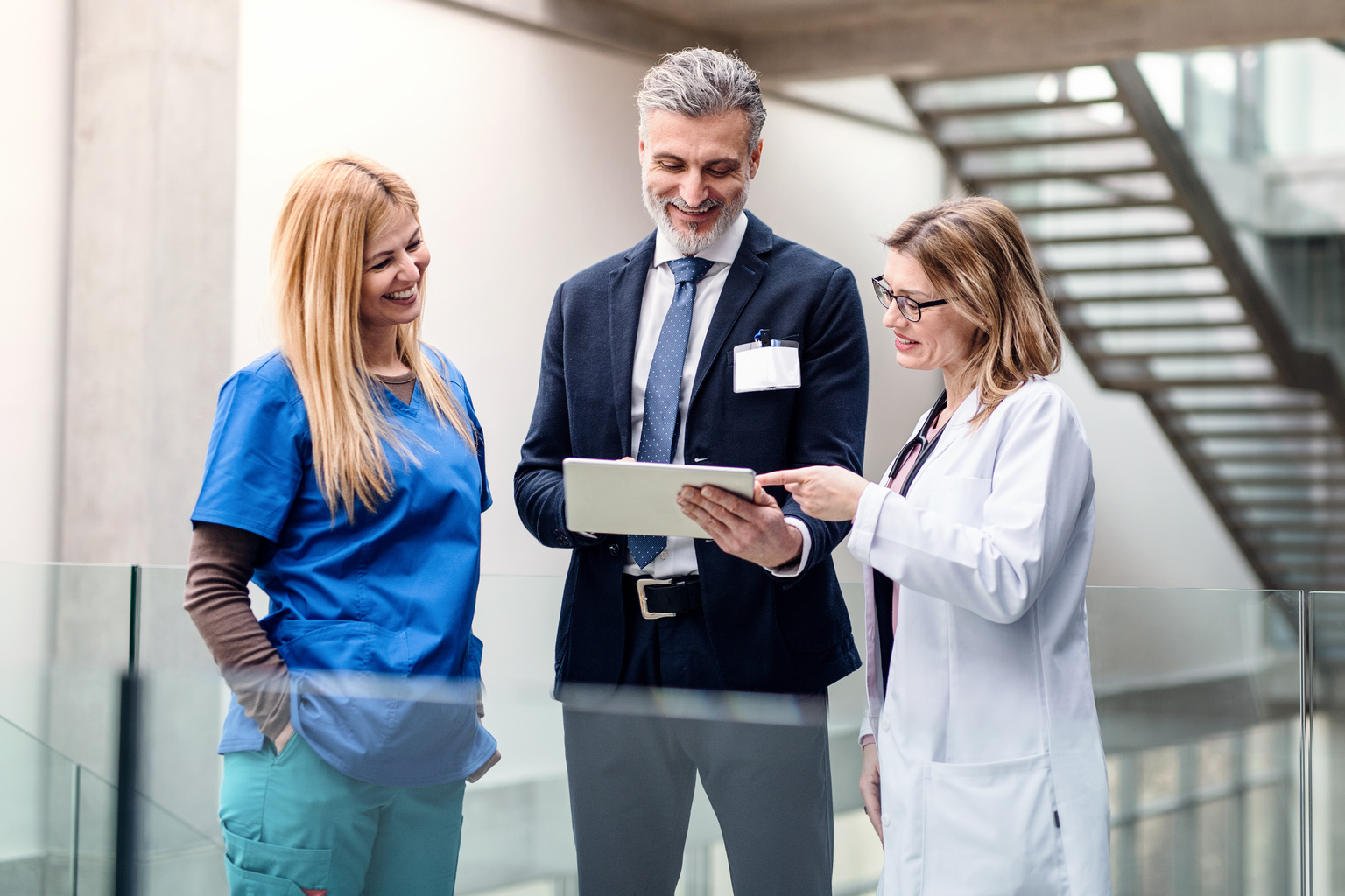 Two doctors talking to hospital administrator