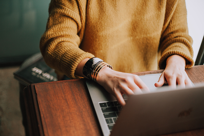 Woman working at laptop on desk