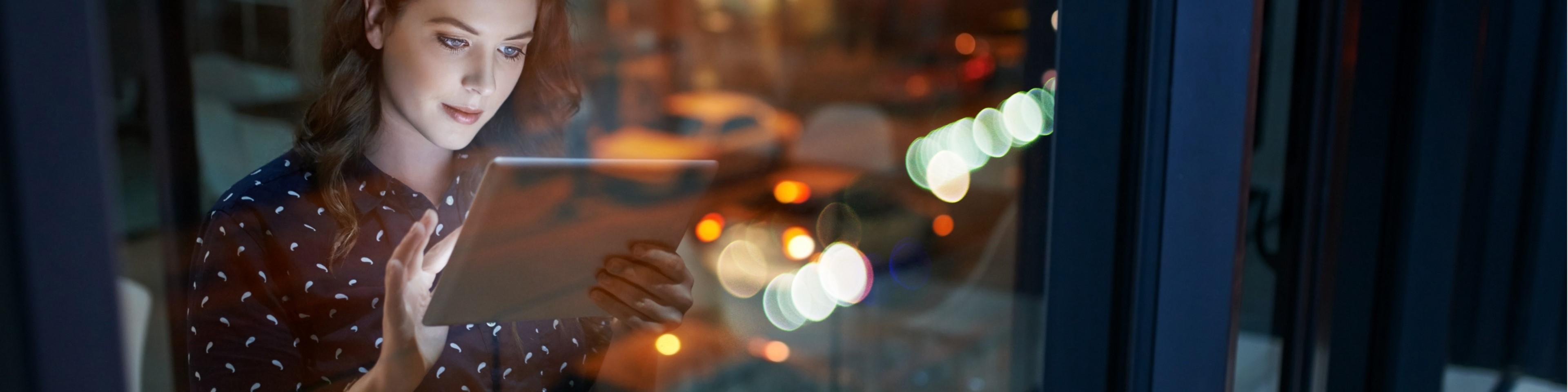 Cropped shot of a young businesswoman working late on a digital tablet in an office