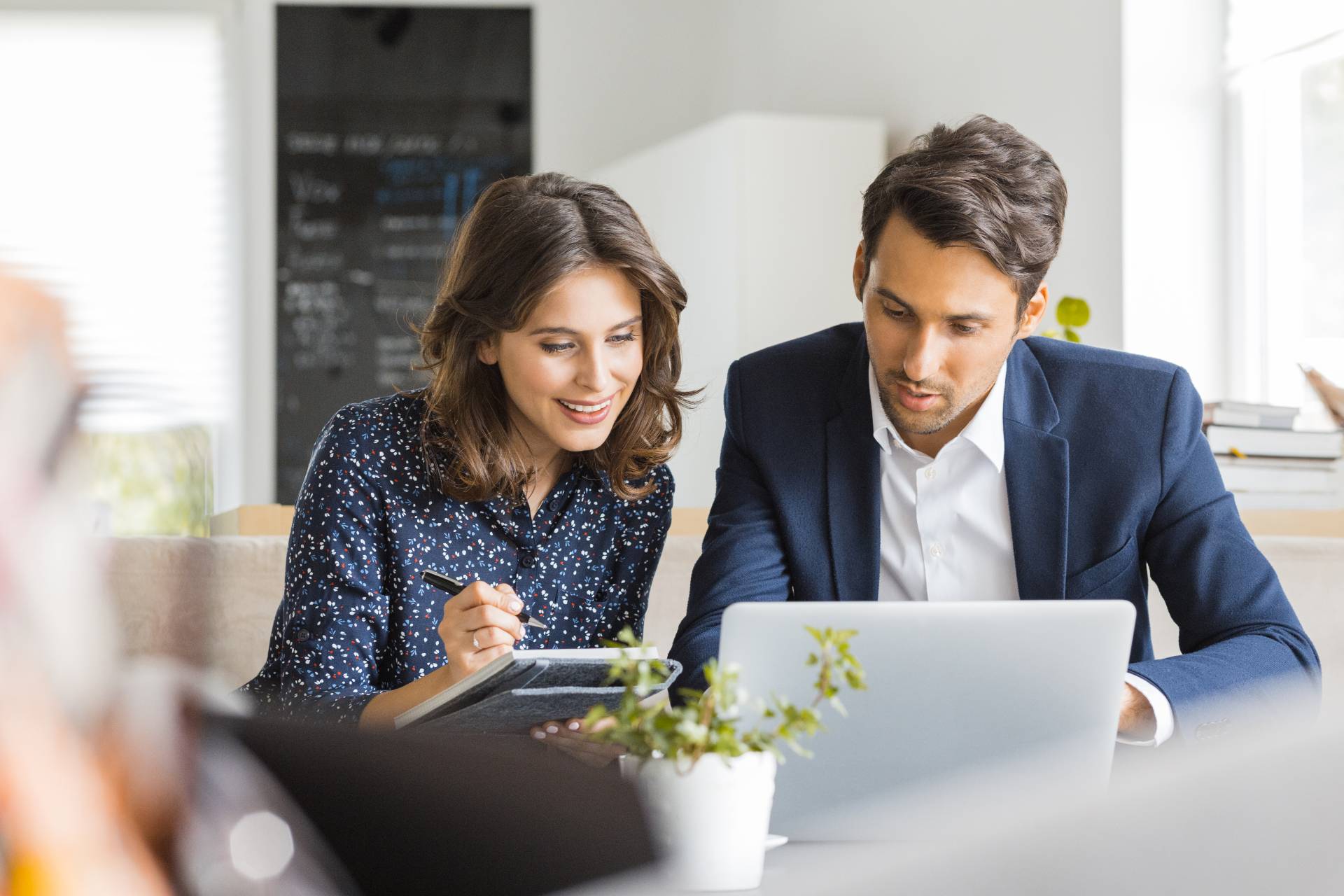 man and woman behind laptop