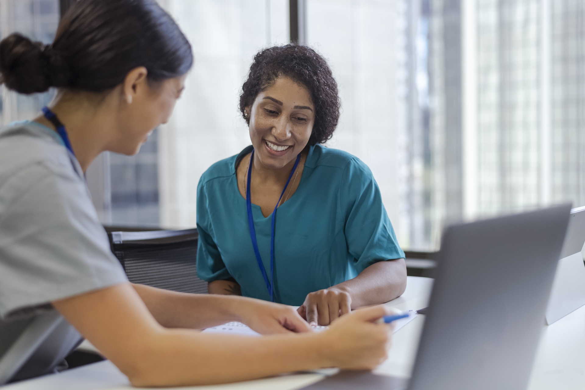 Nurses working together at table