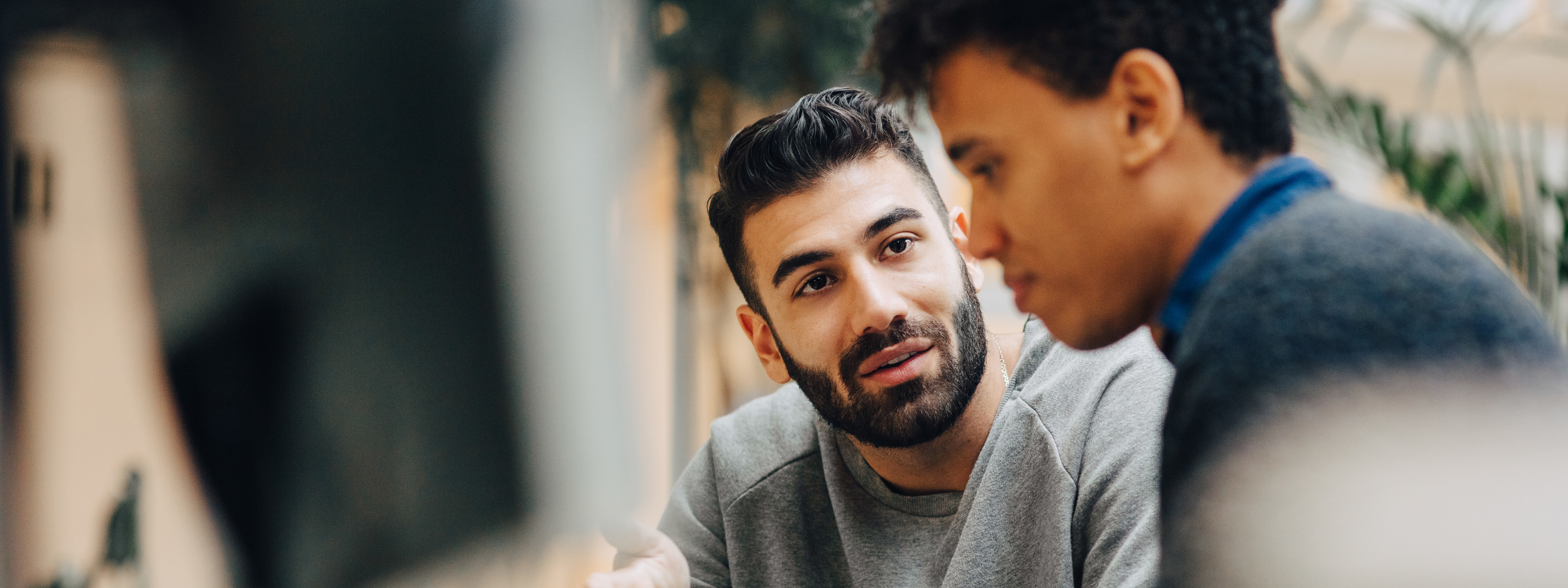 Two men colleagues working together at workplace