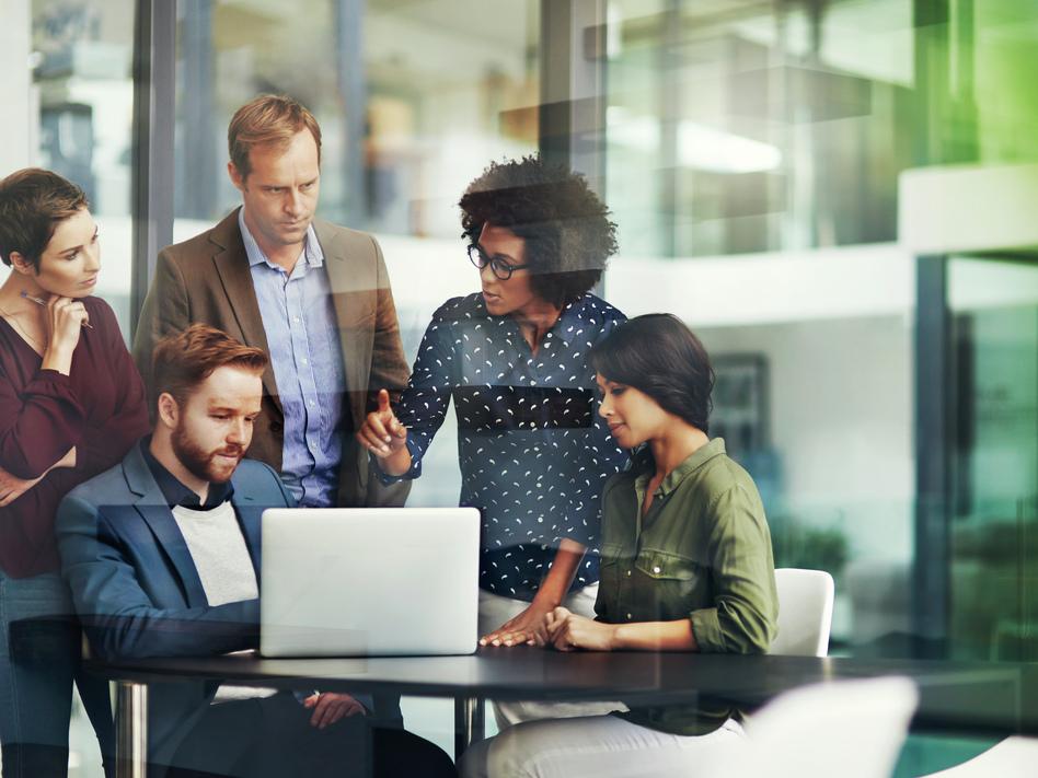 A team sharing expertise in see through conference room