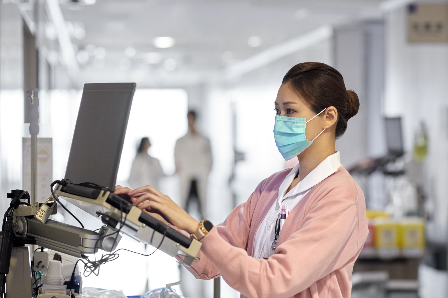 Asian female doctor working at a laptop station