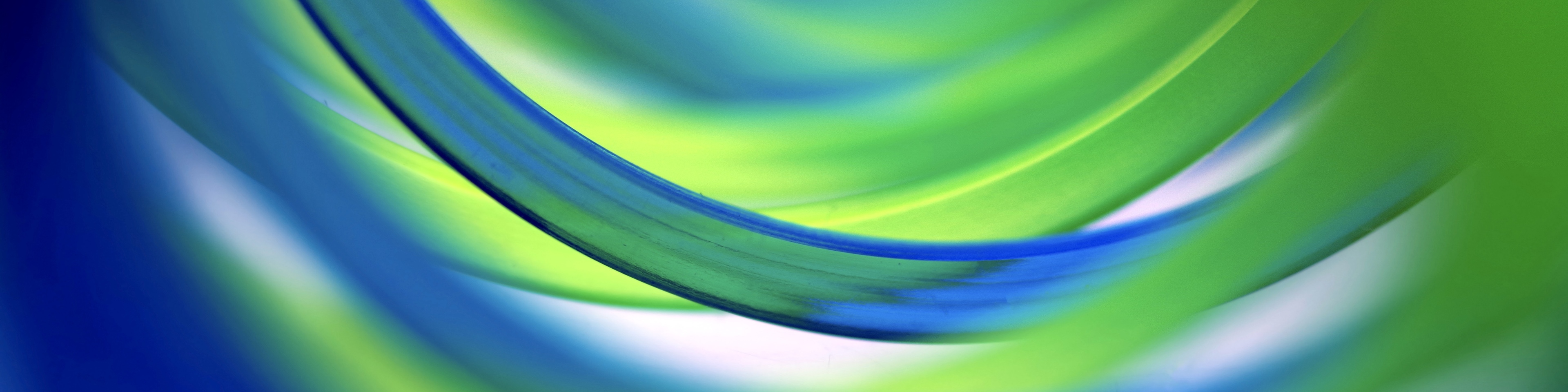 Extreme close-up inside two entwined green and blue coil spring toys