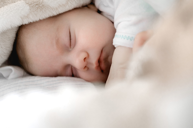 Sleeping baby with blanket surrounding