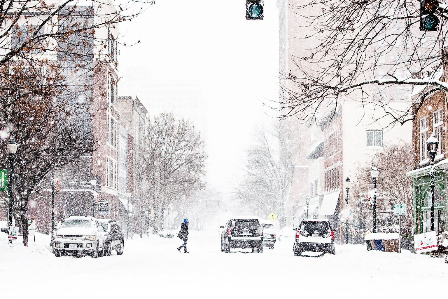 Red traffic light in snow-covered city