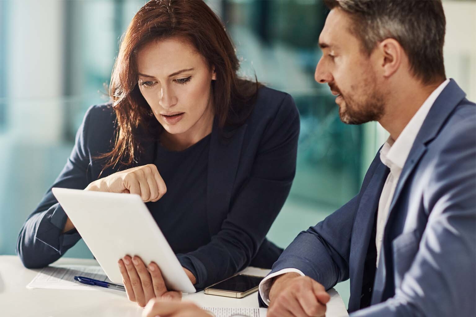 Two professionals collaborating at a computer.