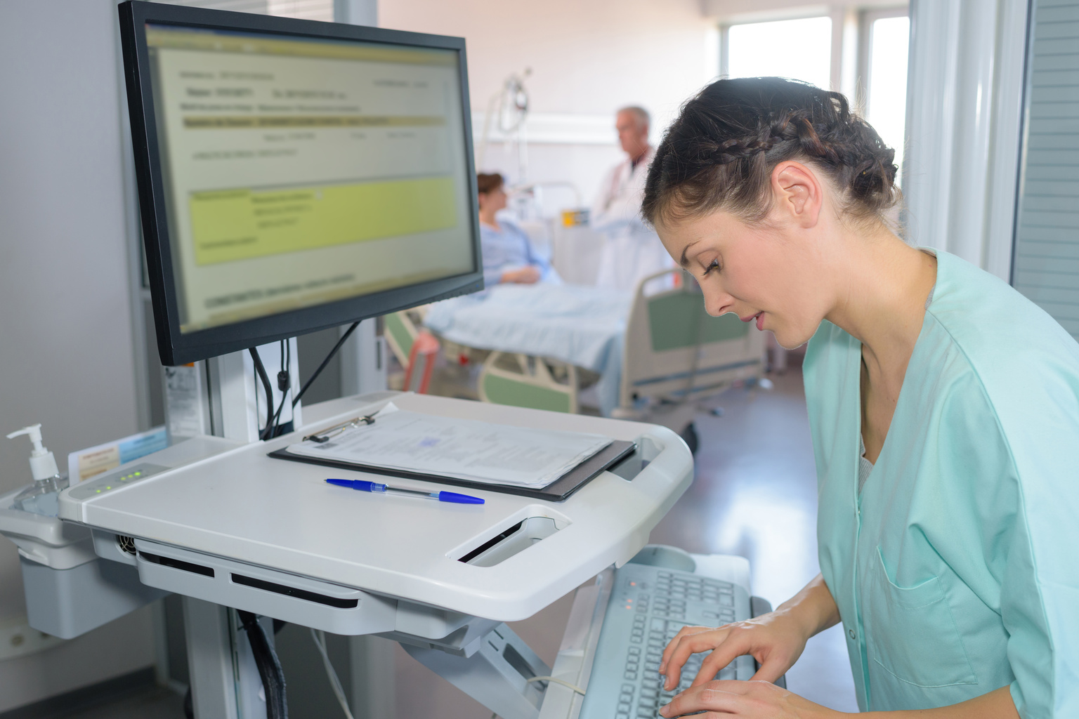 nurse checking hospital screen