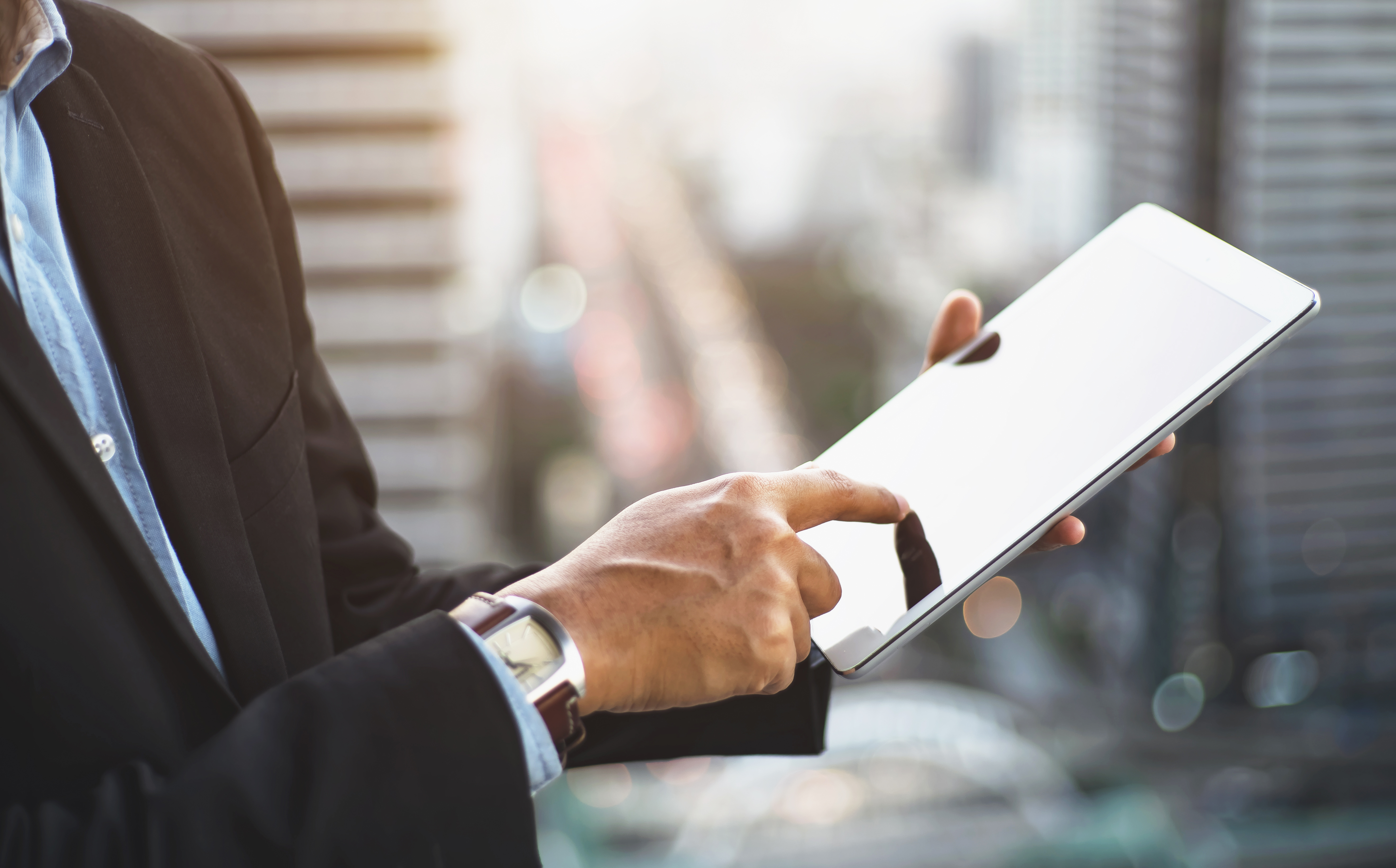 Businessman pointing to tablet.