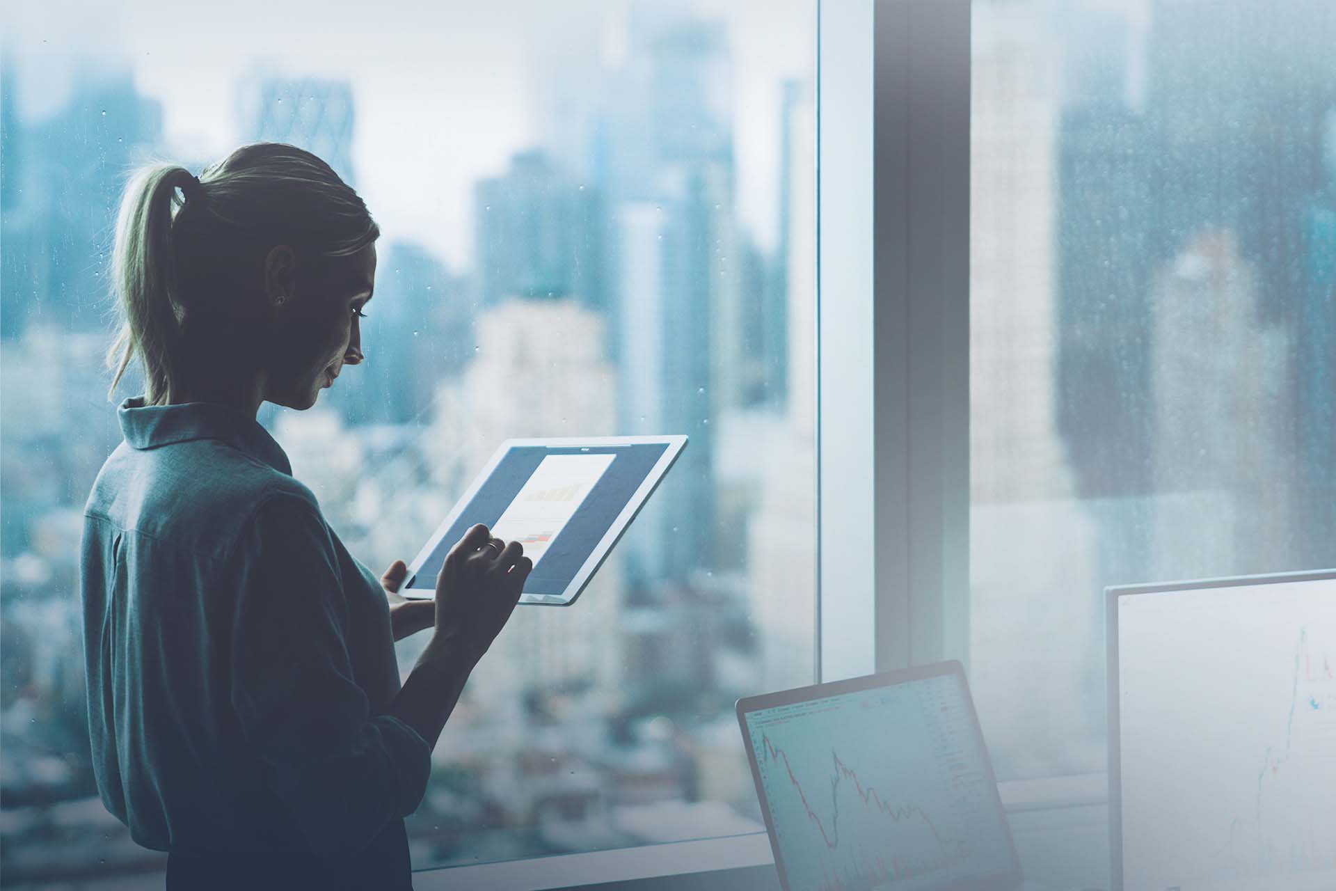 woman on tablet in office building