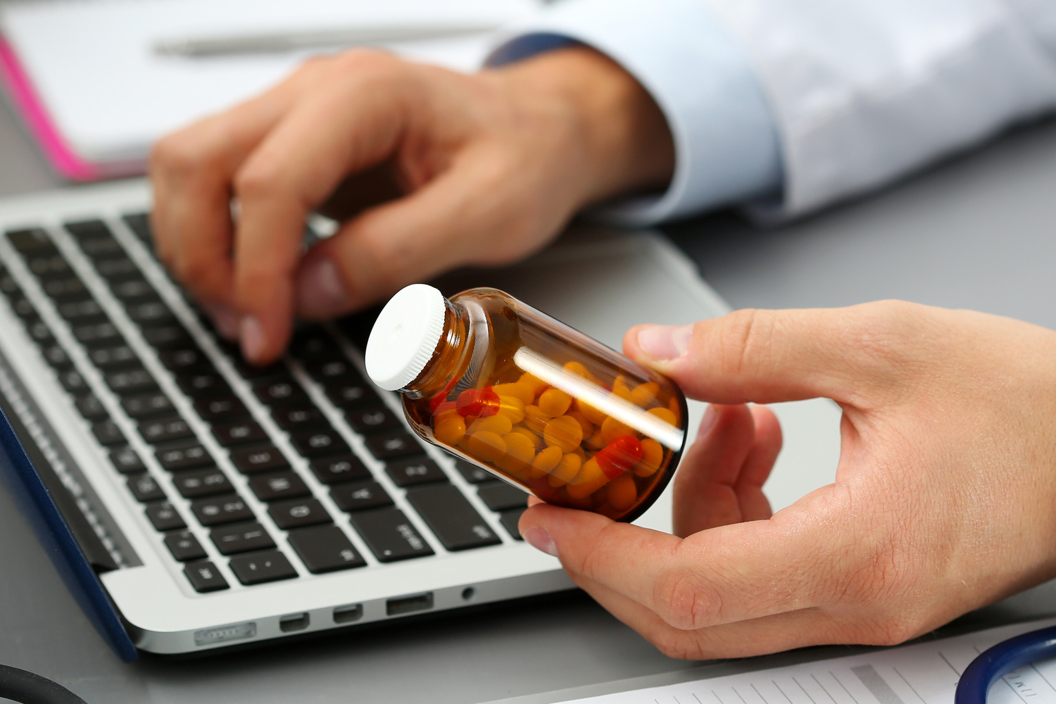 Male medicine doctor hands hold jar of pills