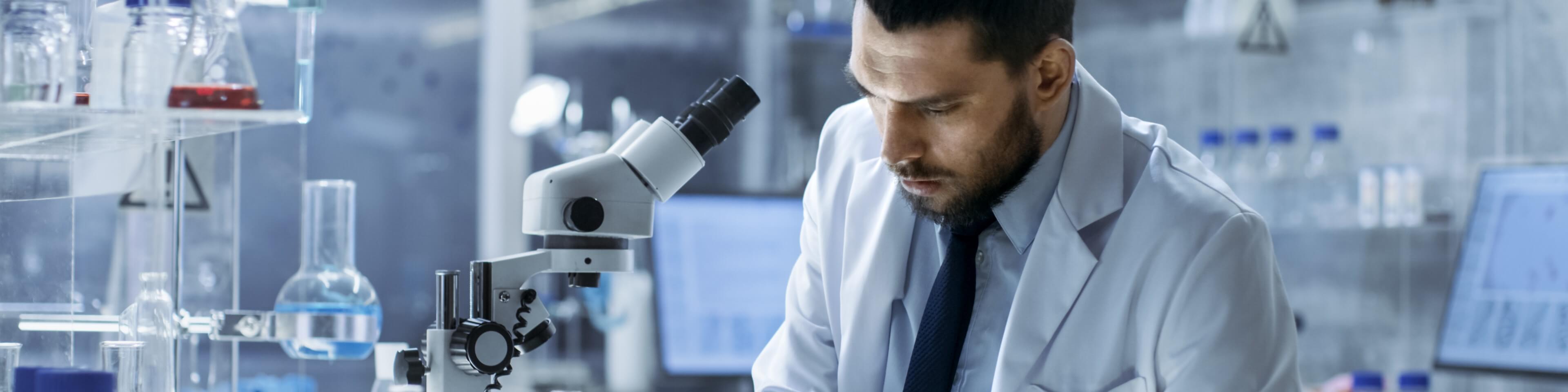 Researcher with a microscope