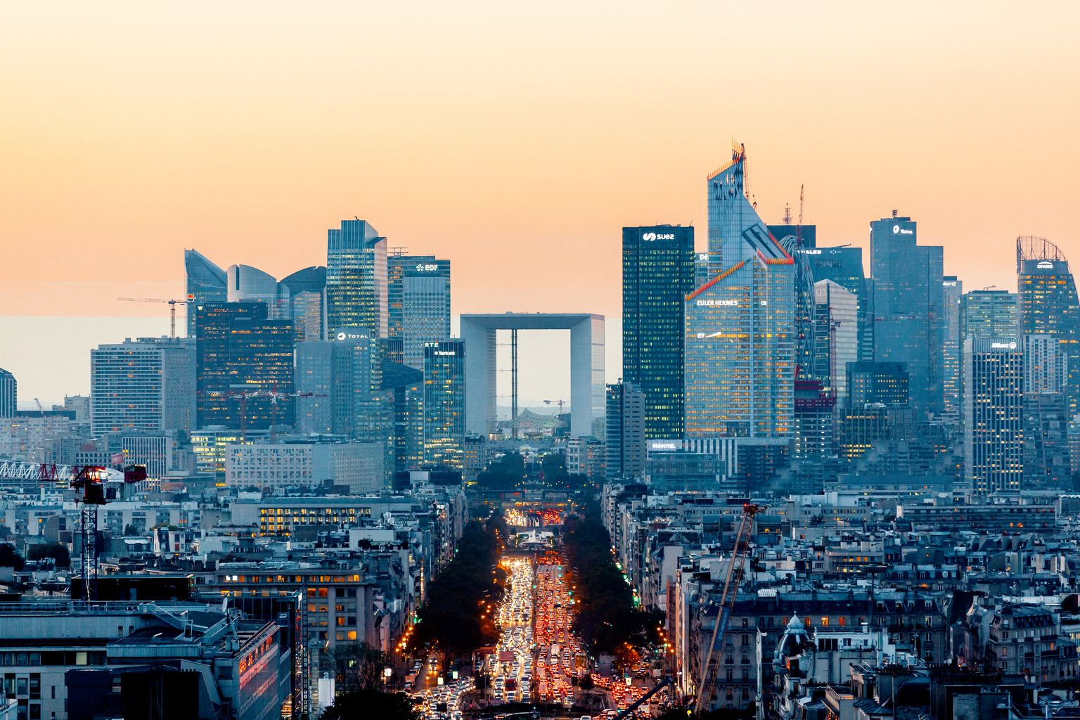 Elevated view of illuminated skyscrapers at La Defense financial district and Avenue des Champs-Elysees at dusk, Paris, France