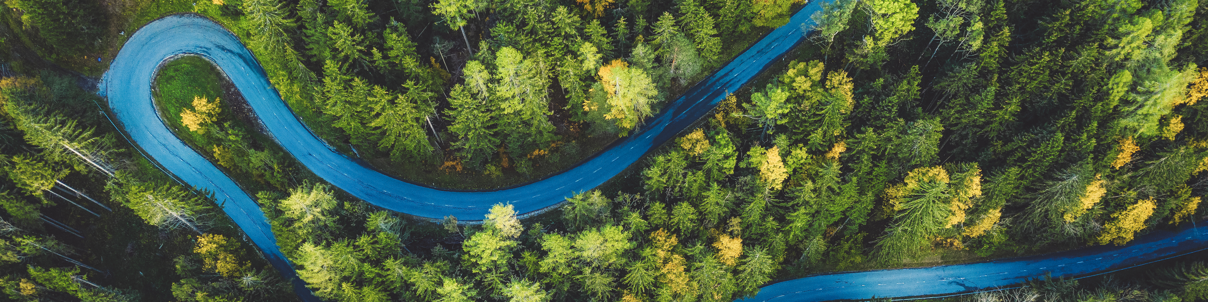 Aerial view of a rural mountain landscape with a curvy road