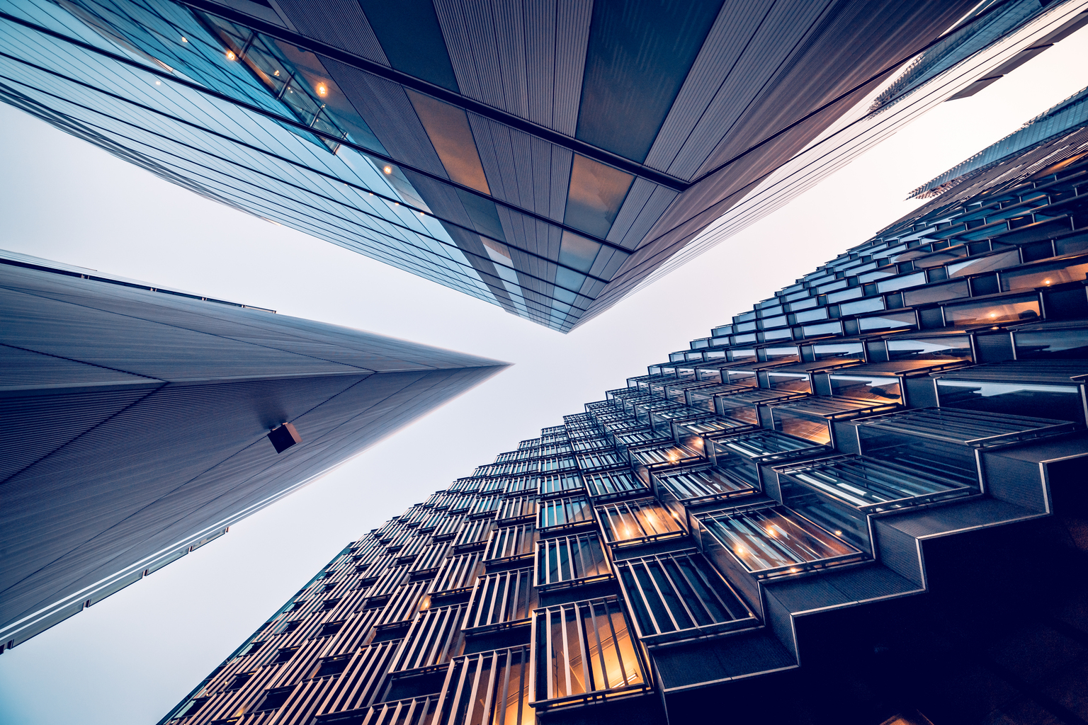 Looking directly up at the skyline of the financial district in central London