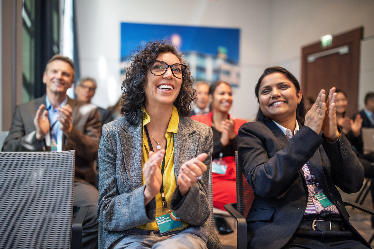 Professionals applauding in a launch event