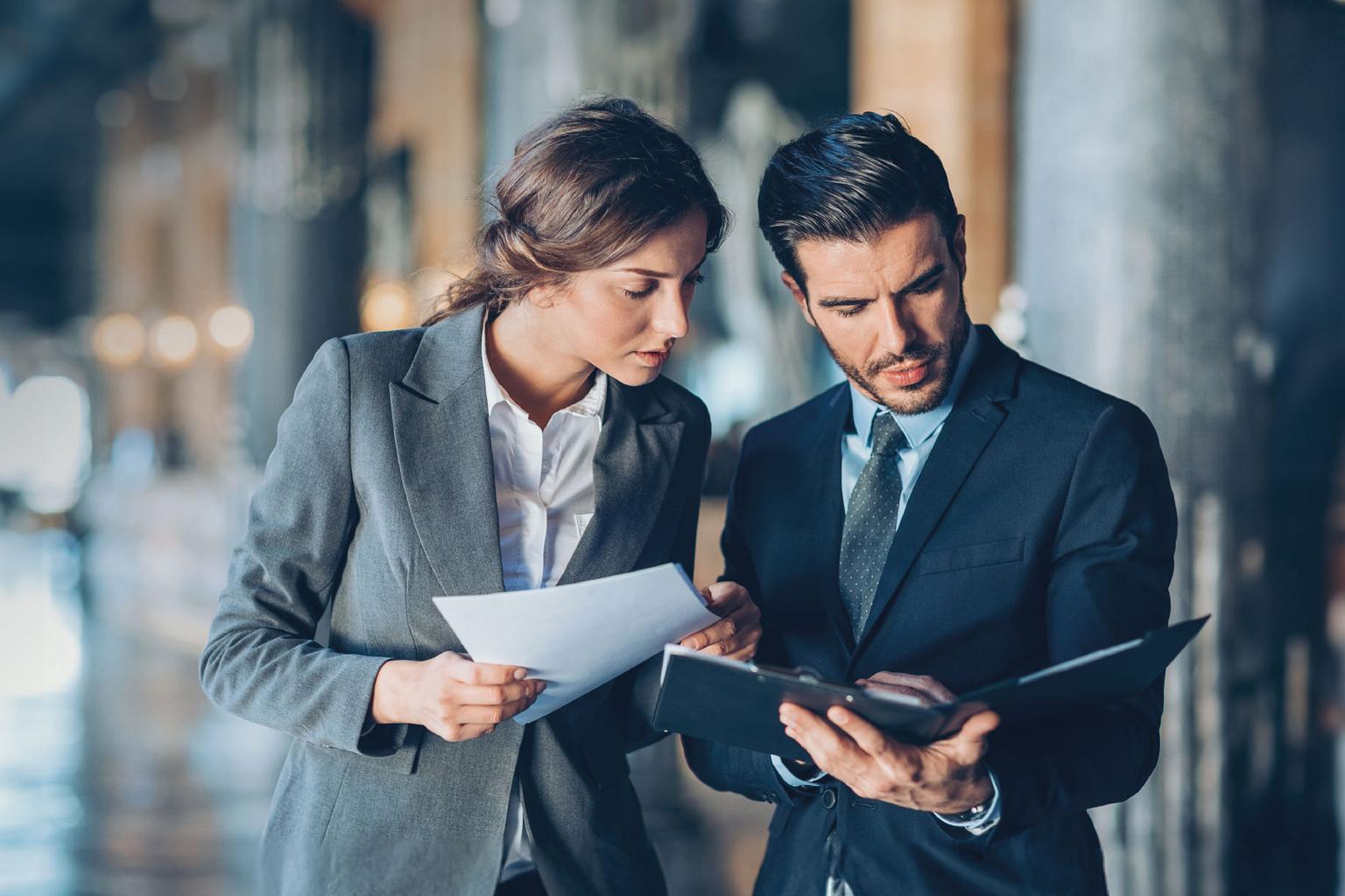 two people looking at docs