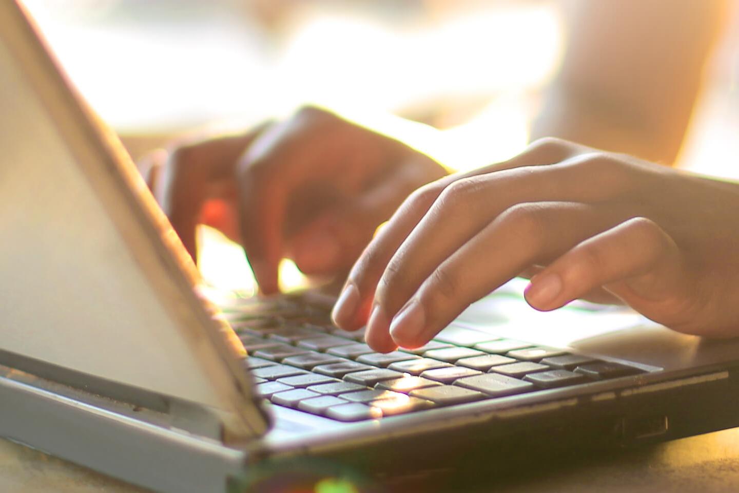 woman typing on laptop