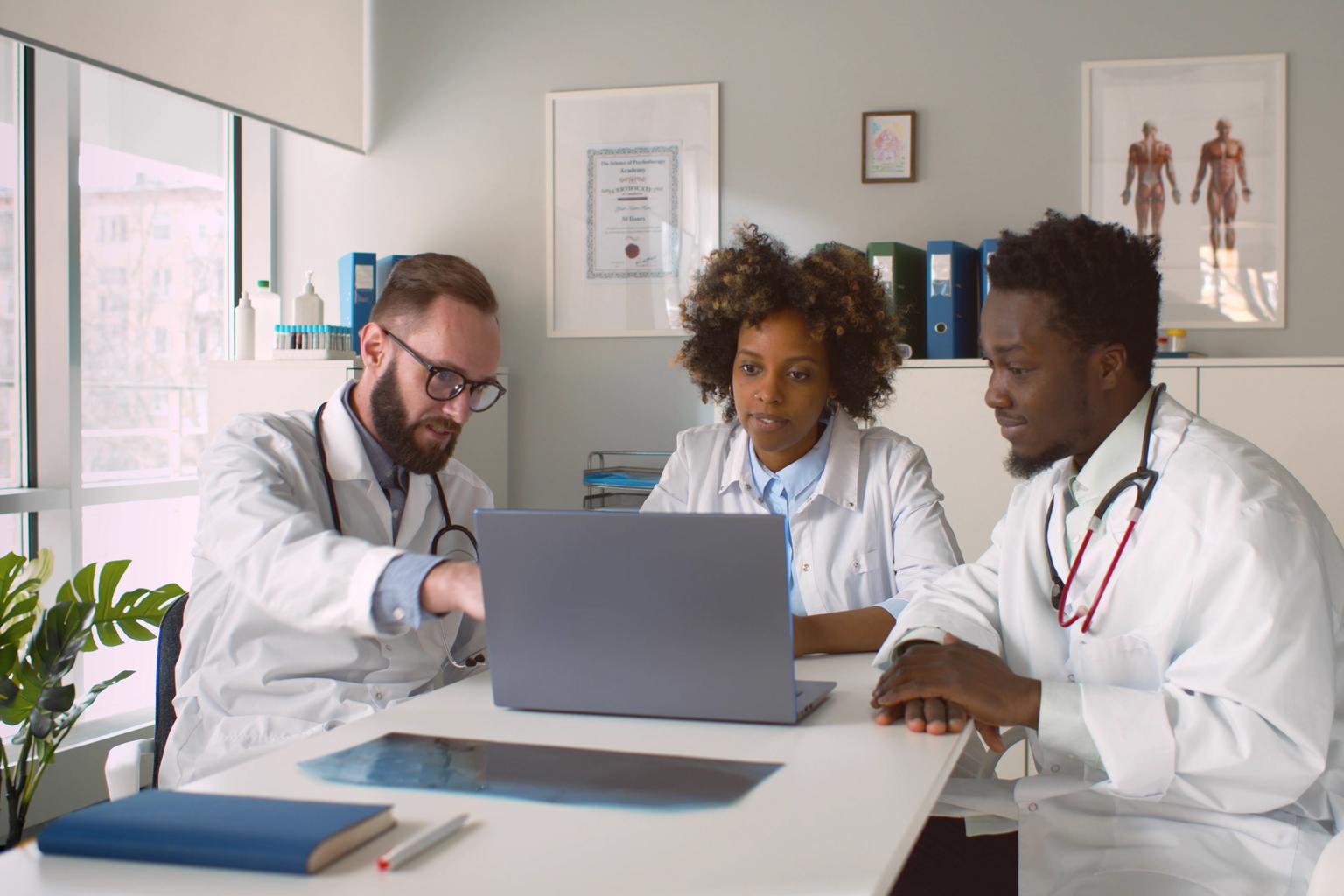 Group of doctors sitting at table discussing treatment options